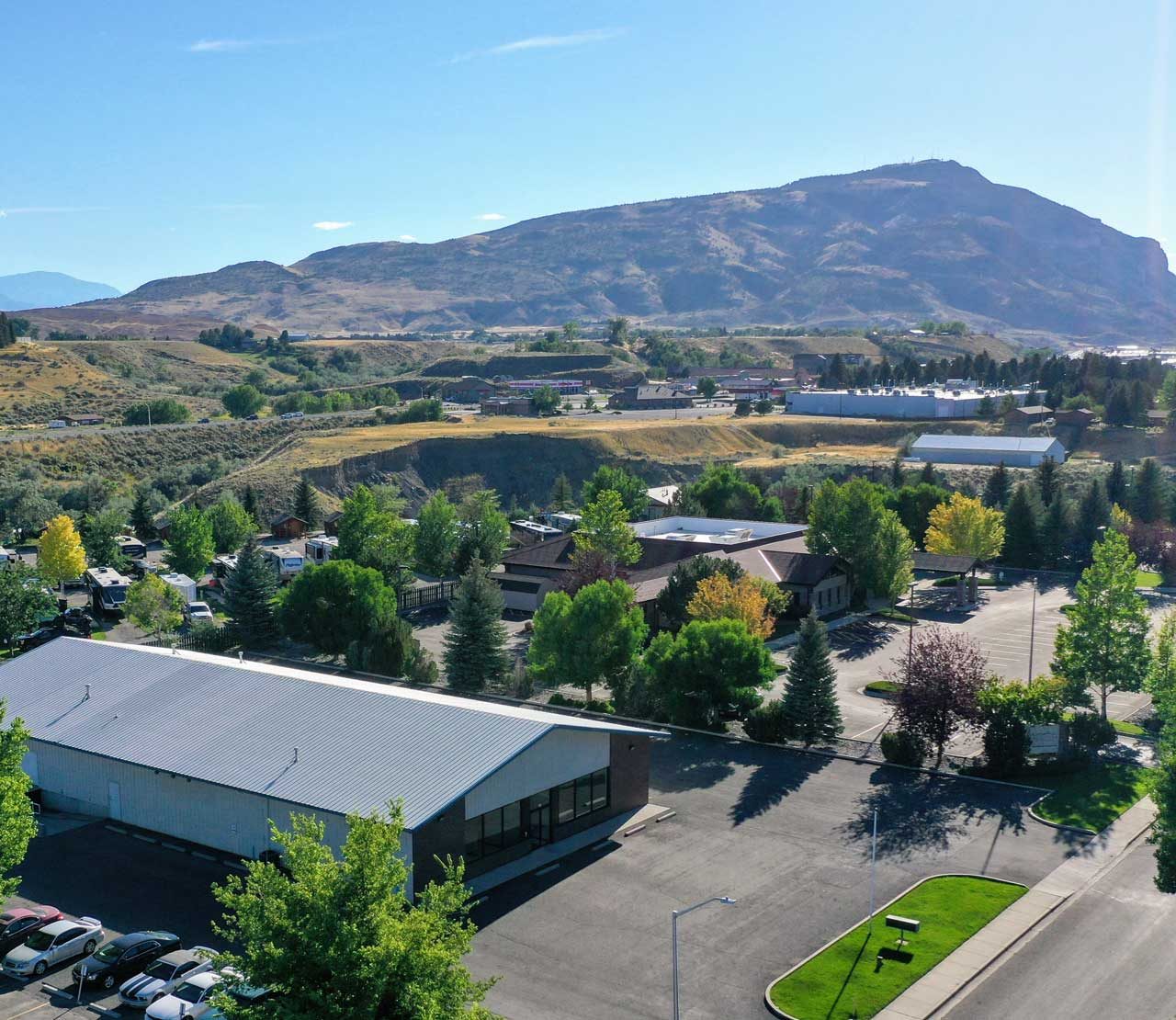 Overhead view of a building with a metal roof with mountains in the background